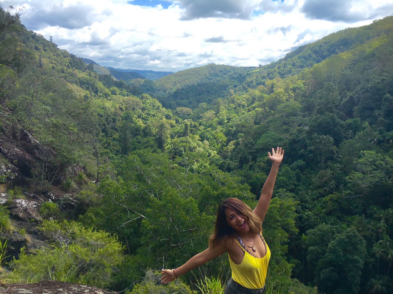 LuLu smiling in front of a green valley