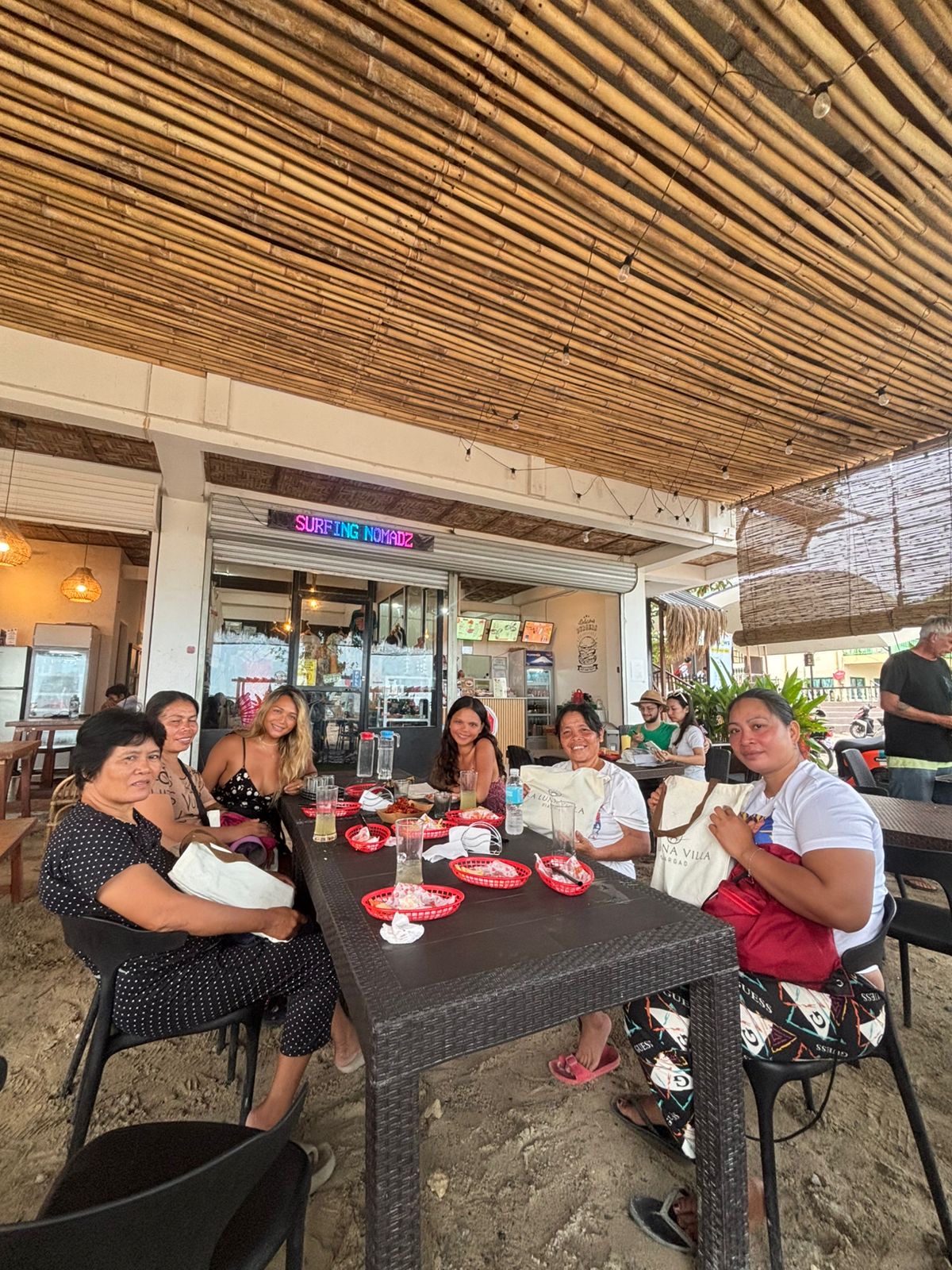 LuLu sharing a meal with women in Siargao